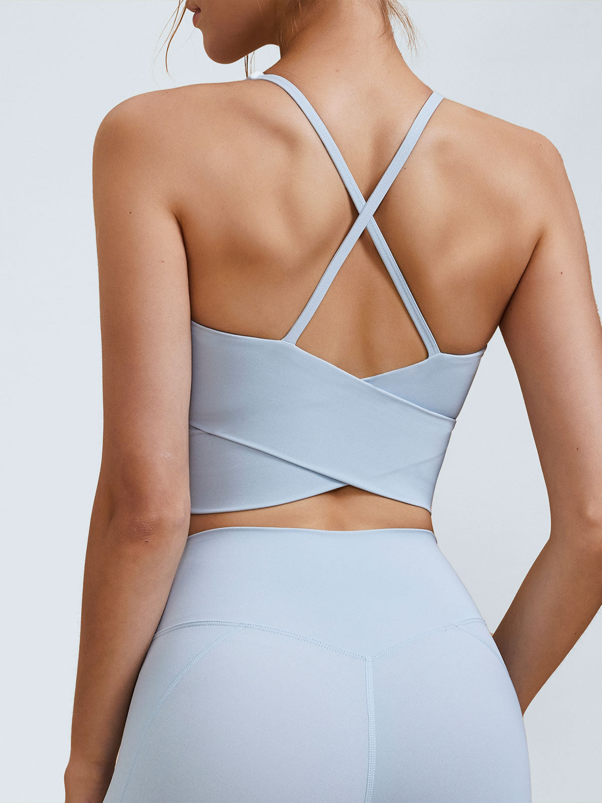 women-knitted-nylon-blended-yoga-sports-bras-light_blue-sustainable-yoga_tops-ryie3g Light Blue V Neck X-Cross Sports Bra - Medium Support - Image 1