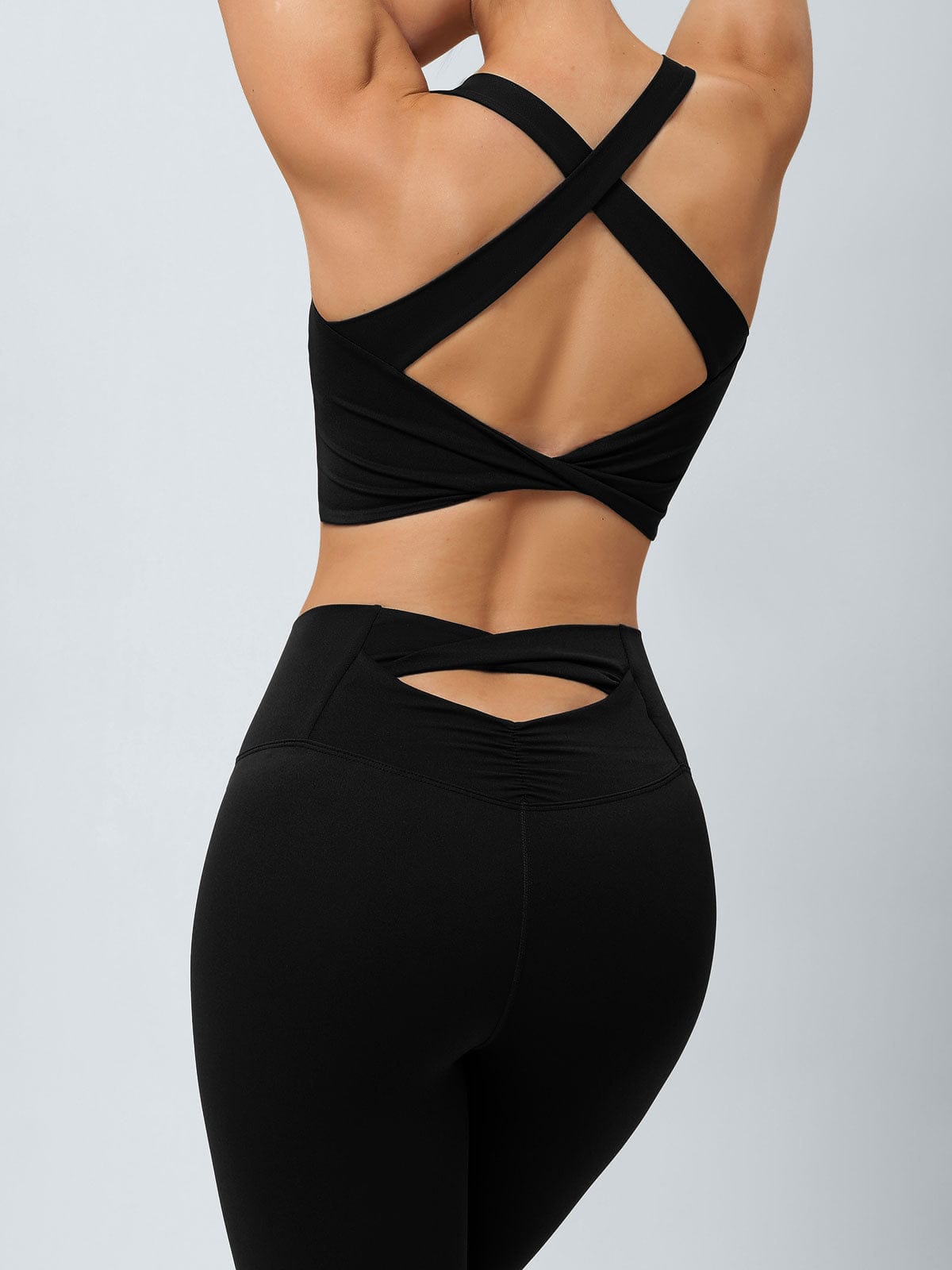 women-knitted-nylon-yoga-sports-bras-sustainable-yoga_tops-vevnzh Black Twist X-Cross Sports Bra - Light Support - Image 1