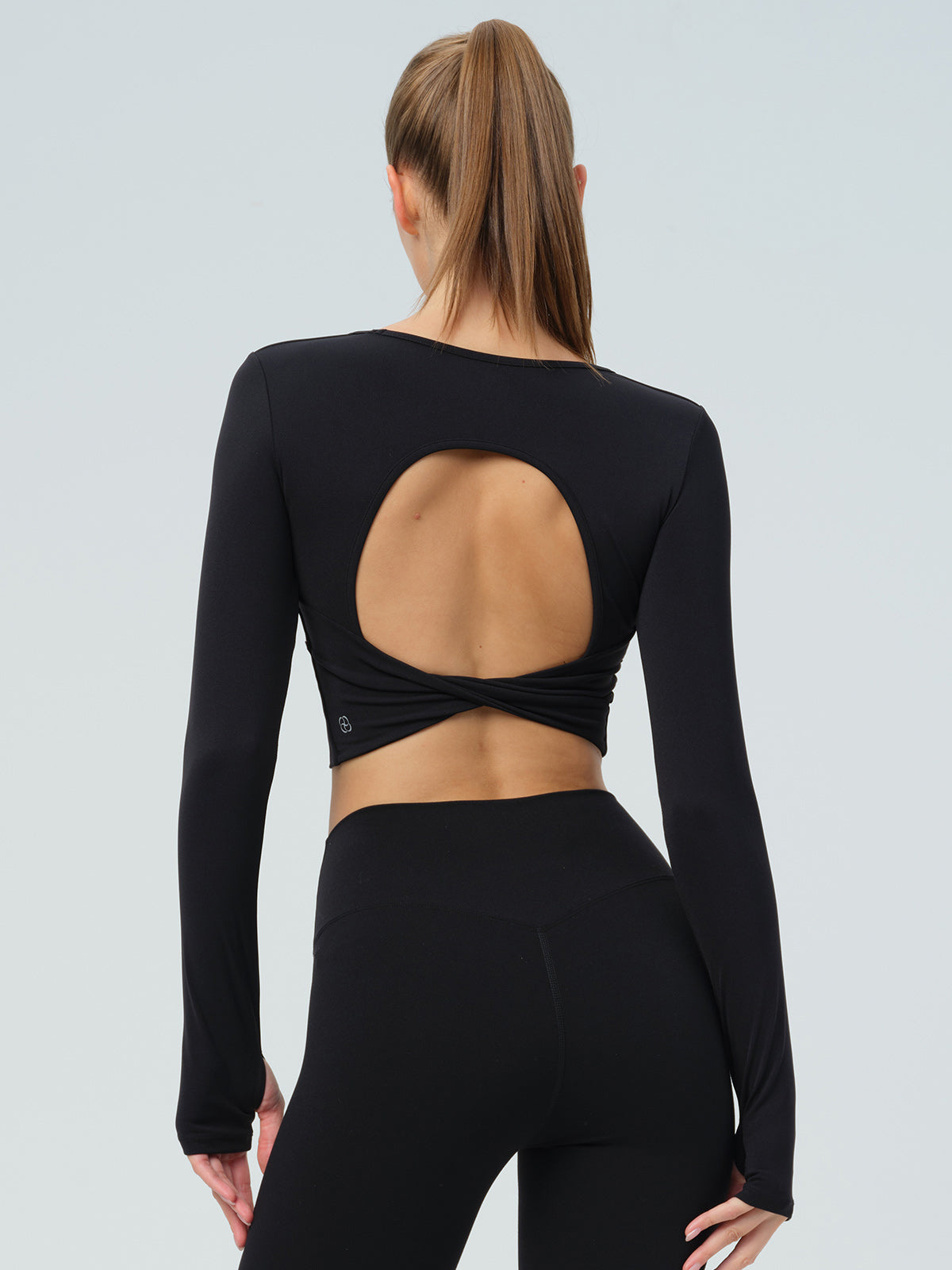 women_s-knitted-nylon-yoga-long-sleeve-top-black-sustainable-yoga_tops-f1k0qu Black Twisted Back Cutout Long Sleeve Top - Image 1